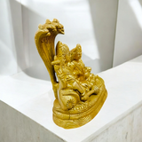 A beautifully crafted brass statue of Lord Lakshmi Narayan resting upon the Shesha Naag, symbolizing wealth, protection, and divine blessings.