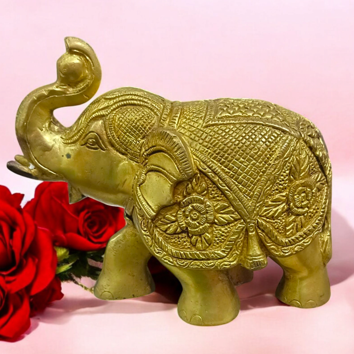 A beautifully crafted large brass elephant statue with an intricate design, symbolizing strength, prosperity, and good fortune, placed on an office table.

