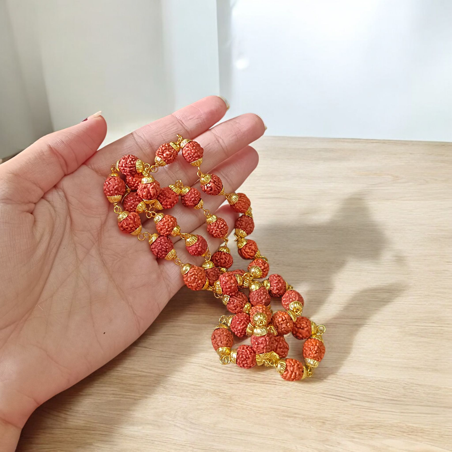 A beautifully handcrafted 5 Face Rudraksha Mala with 37+1 natural Rudraksha beads, golden caps, and lab certification, symbolizing peace and spirituality