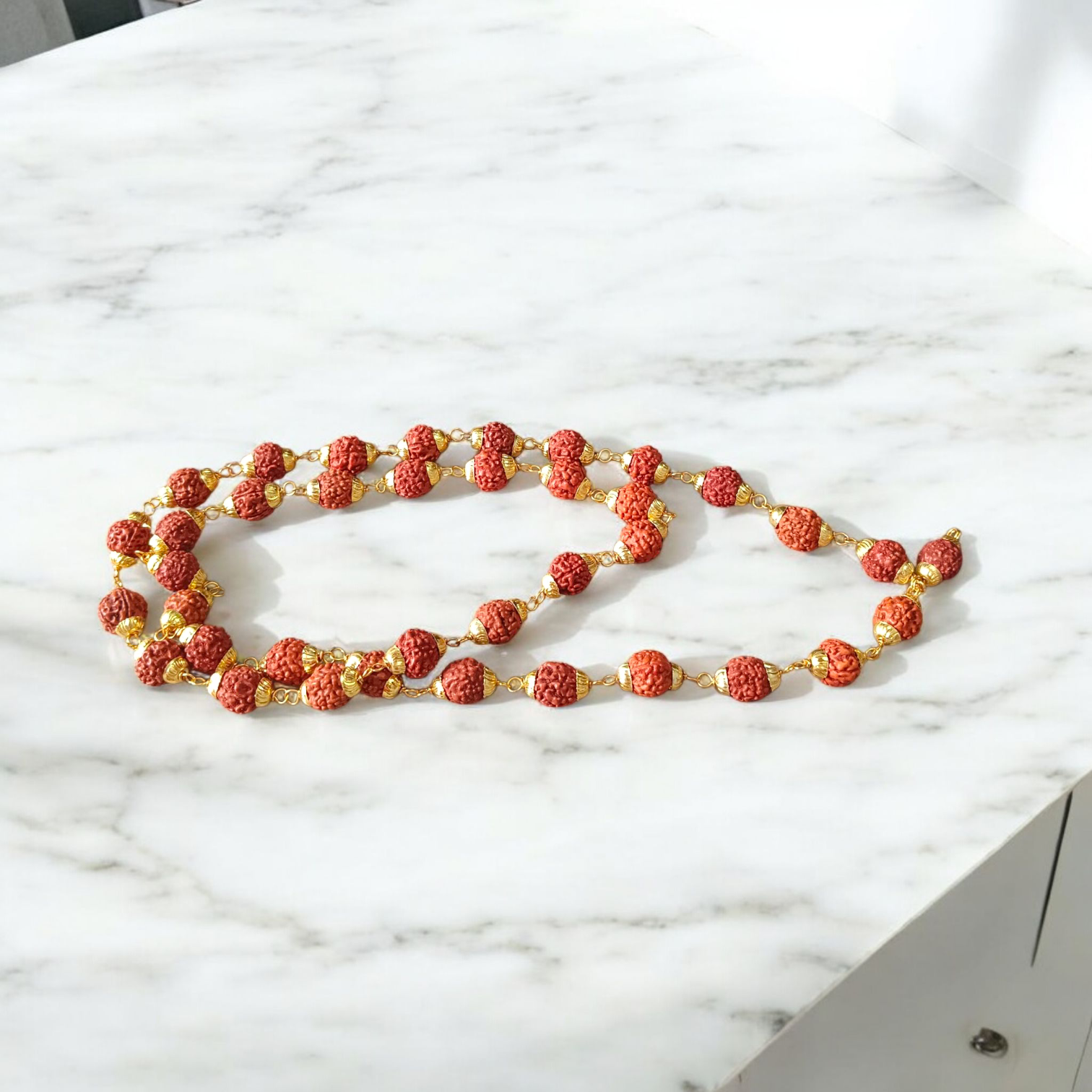 A beautifully handcrafted 5 Face Rudraksha Mala with 37+1 natural Rudraksha beads, golden caps, and lab certification, symbolizing peace and spirituality