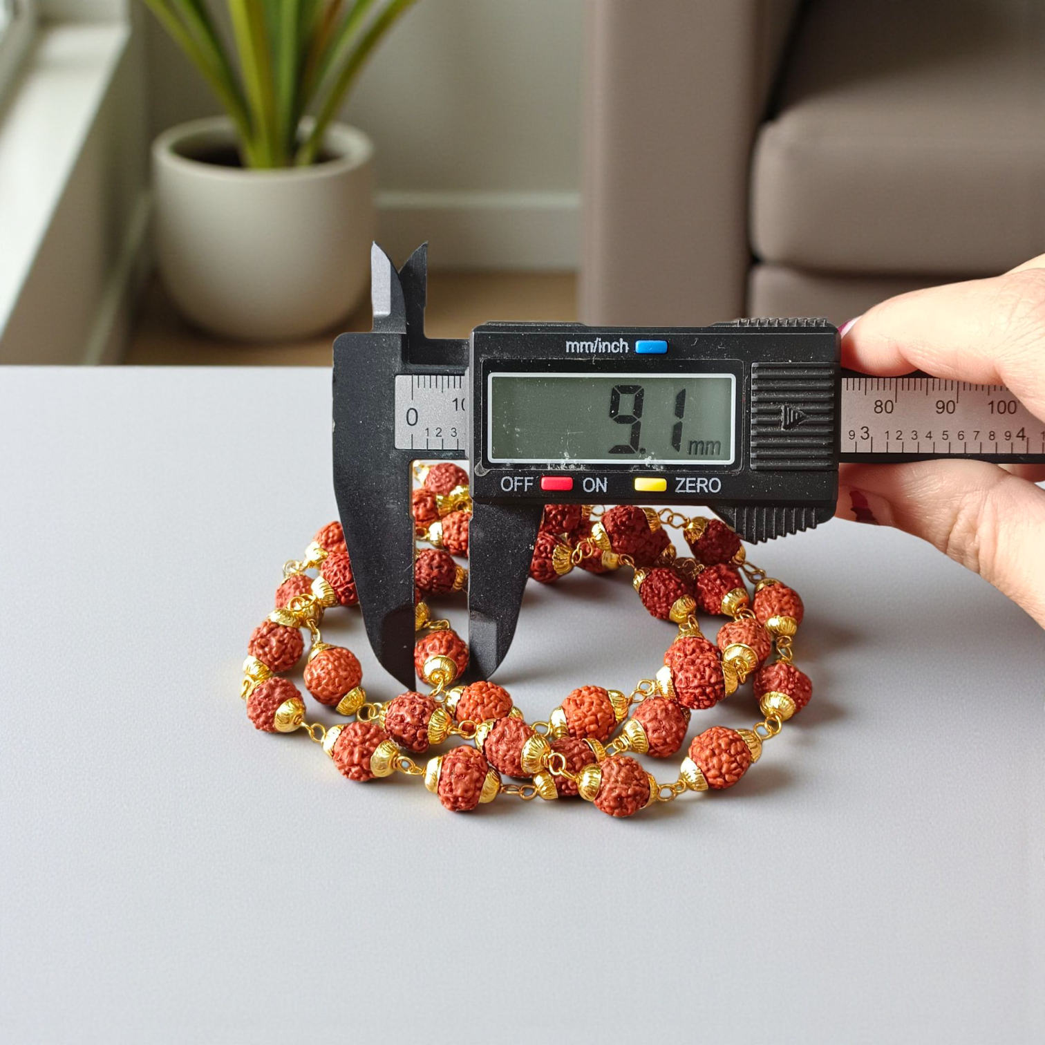 A beautifully handcrafted 5 Face Rudraksha Mala with 37+1 natural Rudraksha beads, golden caps, and lab certification, symbolizing peace and spirituality