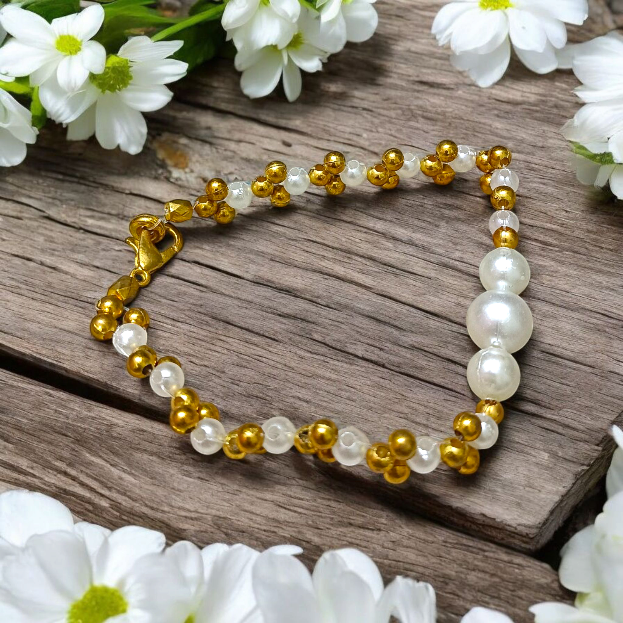 A beautifully handcrafted white and golden pearl designer bracelet, stretchable and elegant—perfect for girls, women, and festive occasions