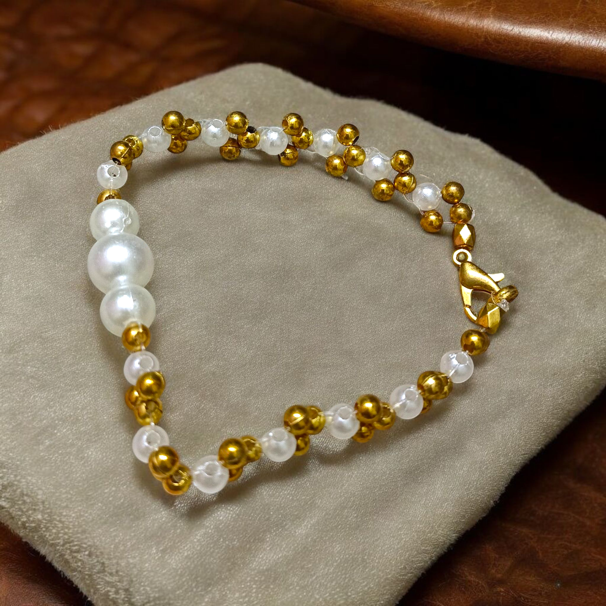 A beautifully handcrafted white and golden pearl designer bracelet, stretchable and elegant—perfect for girls, women, and festive occasions