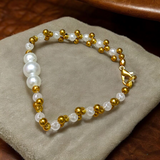 A beautifully handcrafted white and golden pearl designer bracelet, stretchable and elegant—perfect for girls, women, and festive occasions
