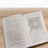 A book titled Sampurna Vastu Shastra & Dosh Nivaran in Hindi with a large font, placed on a desk with a peaceful and harmonious background symbolizing positive energy flow.