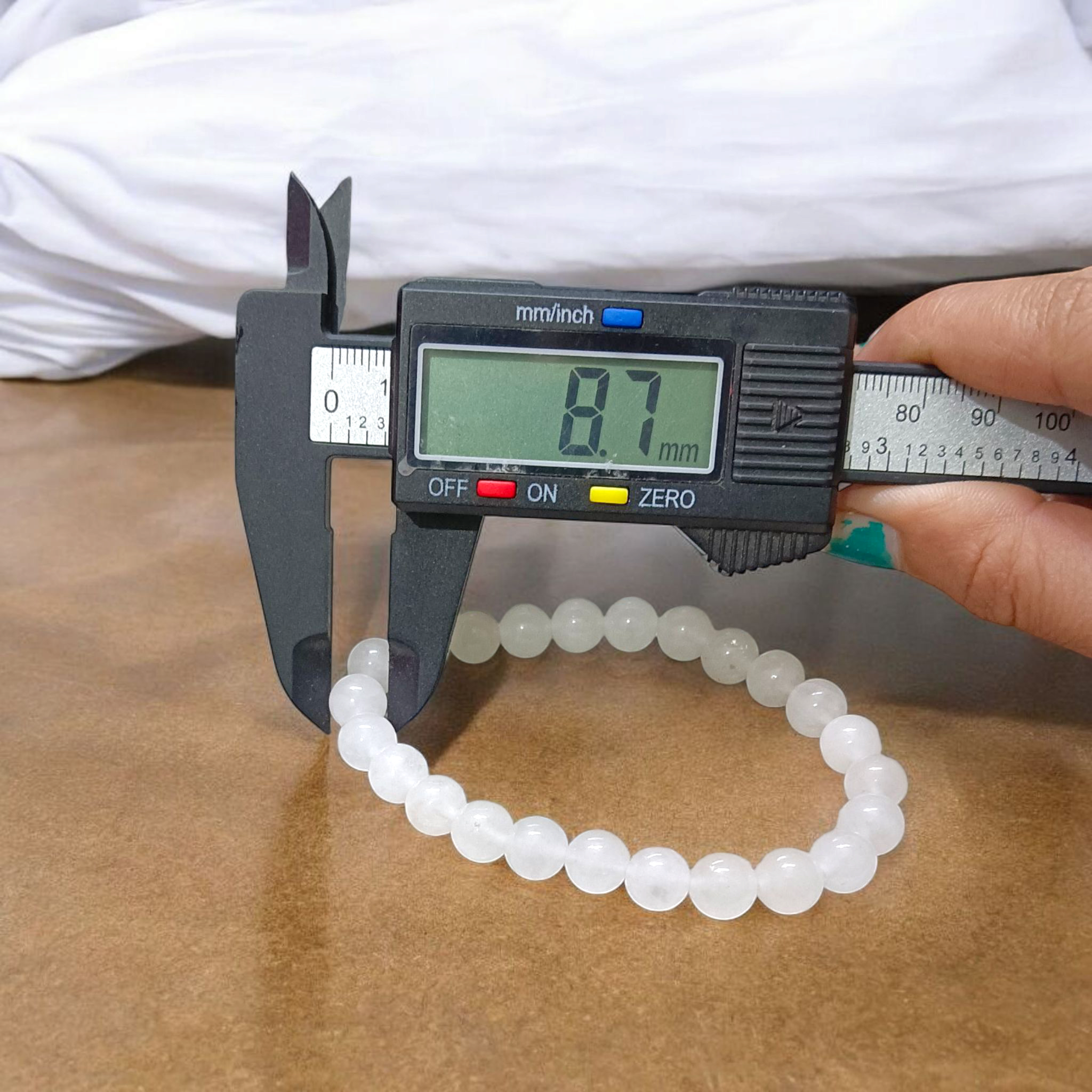 A close-up image of a White Agate (Safed Hakik) Bracelet, showcasing the lab-certified genuine white agate stones
