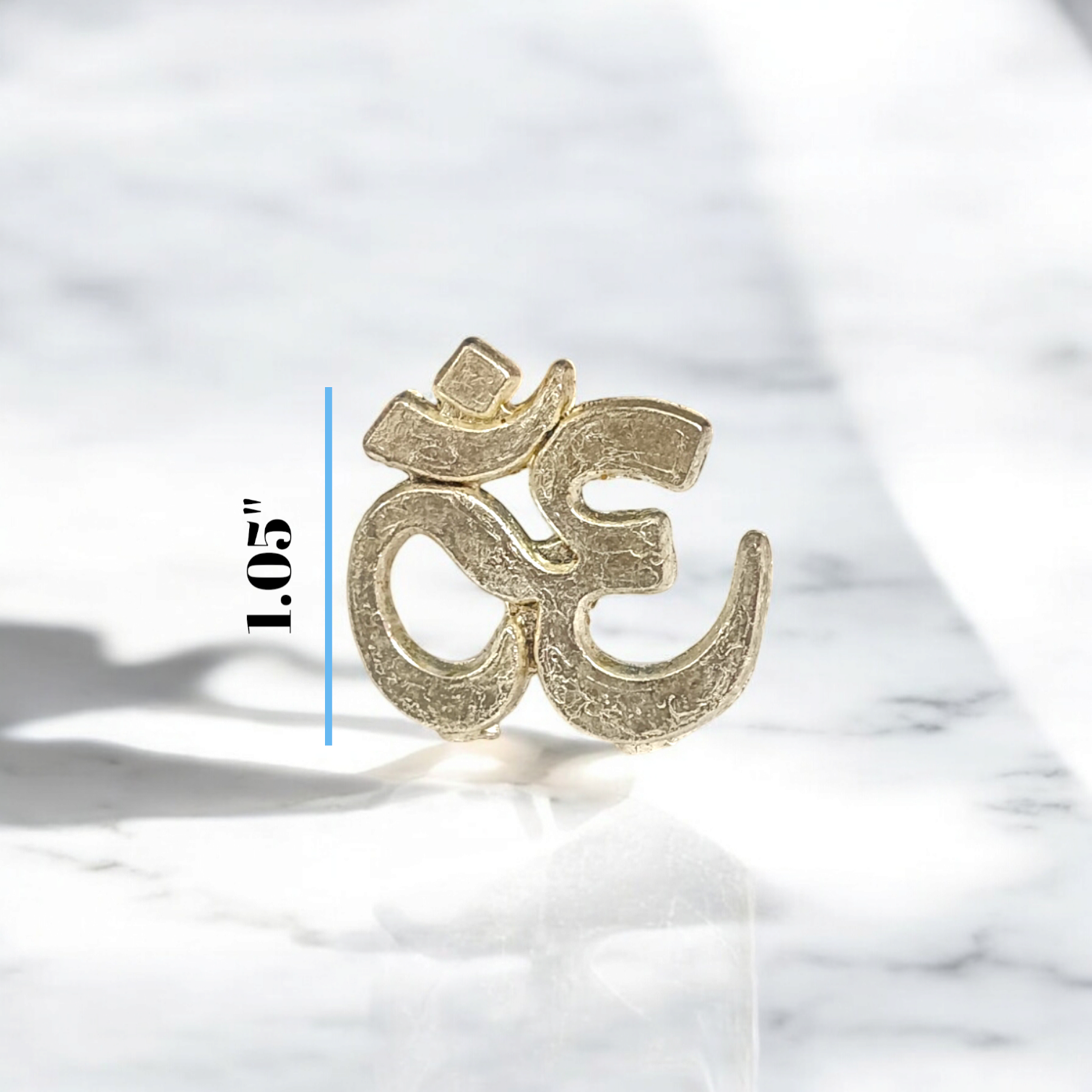  A close-up image of the Om Tilak Sancha, a brass stamp used for applying sacred Om tilak on the forehead during worship rituals and religious ceremonies.