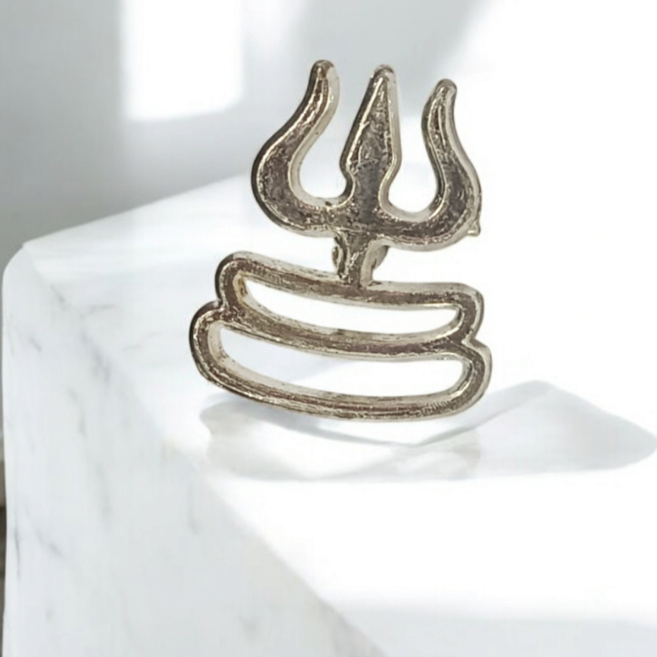 A close-up image of the Trishul Tripund Tilak Thappa, a brass stamp used to apply sacred tilak on the forehead during worship ceremonies.