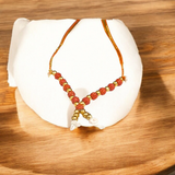 A close-up view of a Rudraksha mala garland, made of small beads, designed for adorning the idol of Laddu Gopal, symbolizing devotion and spiritual connection.