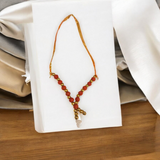 A close-up view of a Rudraksha mala garland, made of small beads, designed for adorning the idol of Laddu Gopal, symbolizing devotion and spiritual connection.