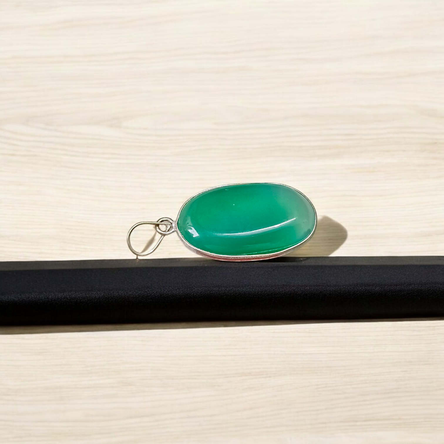 A close-up view of the Original Green Emerald Penna Pendant, showcasing the lab-certified green emerald gemstone, perfect for enhancing emotional wellbeing.