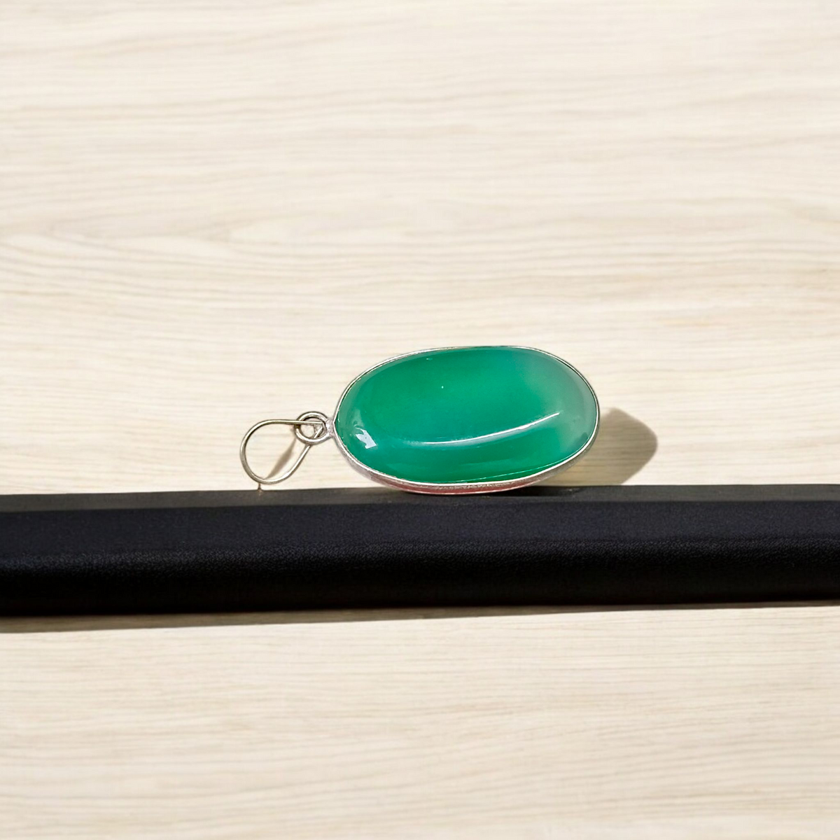 A close-up view of the Original Green Emerald Penna Pendant, showcasing the lab-certified green emerald gemstone, perfect for enhancing emotional wellbeing.