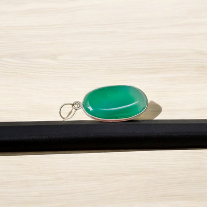 A close-up view of the Original Green Emerald Penna Pendant, showcasing the lab-certified green emerald gemstone, perfect for enhancing emotional wellbeing.