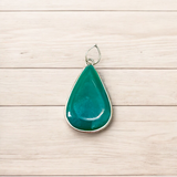 A close-up view of the Original Green Emerald Penna Pendant, showcasing the lab-certified green emerald gemstone, perfect for enhancing emotional wellbeing.