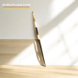 A collection of sharp natural porcupine quills arranged neatly on a wooden surface, showcasing their natural texture and untreated finish