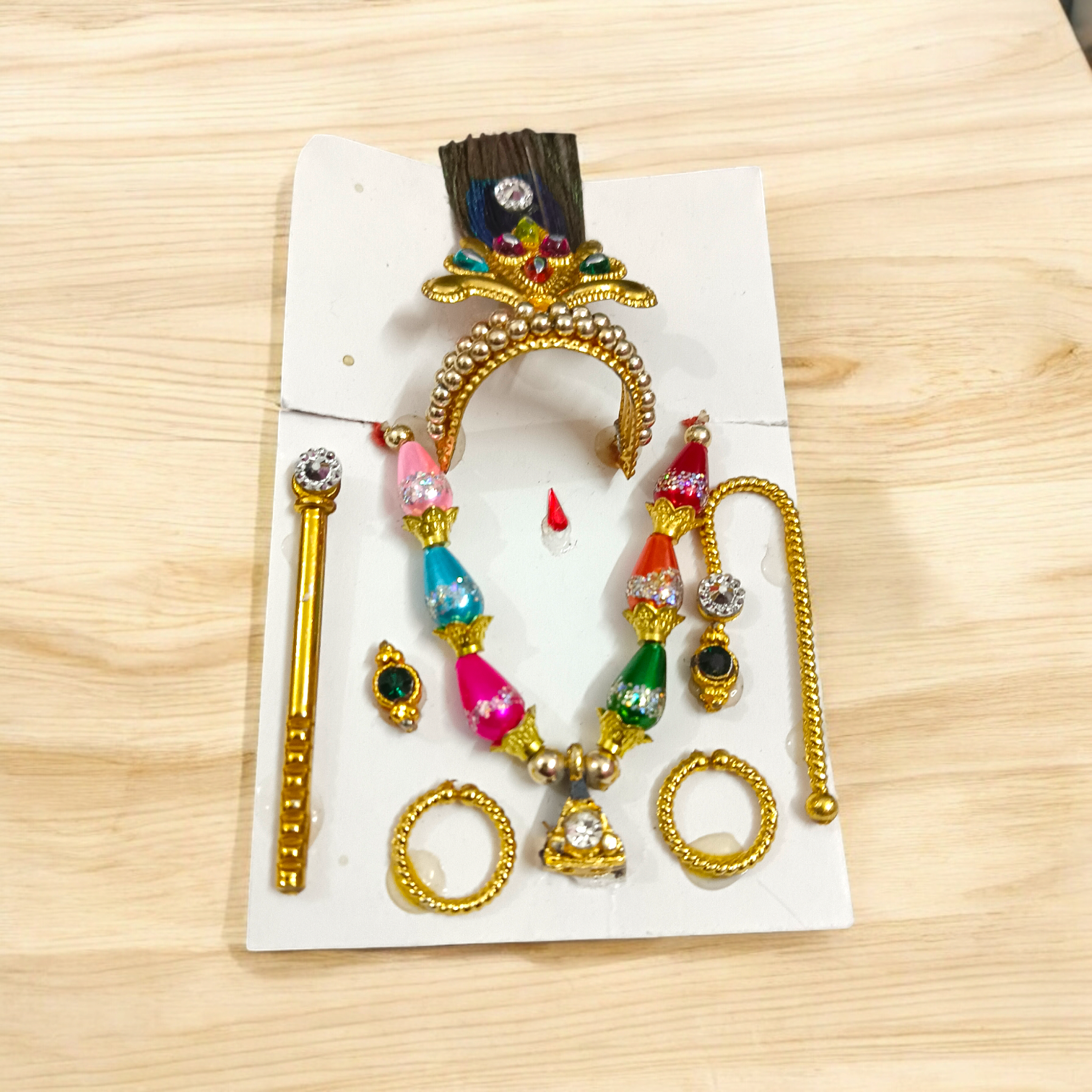 A complete Laddu Gopal Shringaar Set including Mukut, Earrings, Bangles, Mala, and Bansuri for adorning Krishna idols.