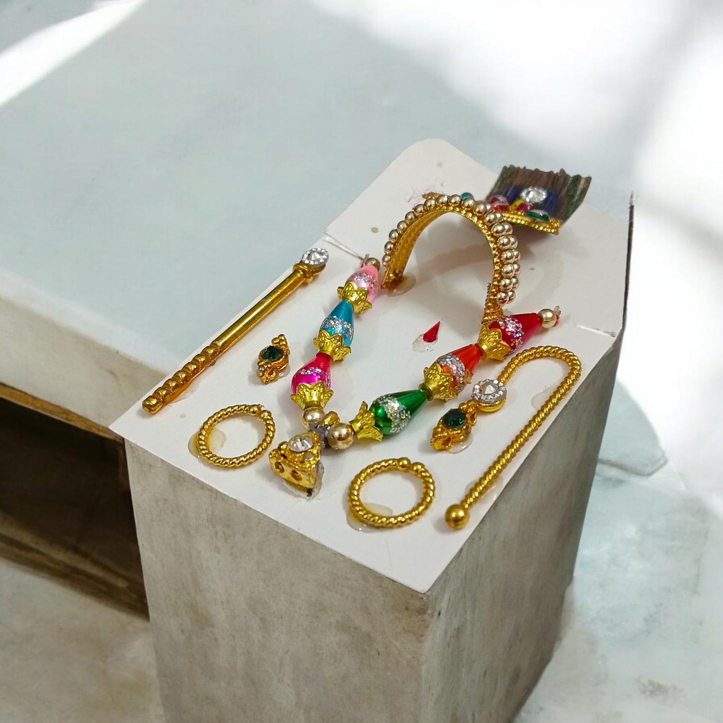 A complete Laddu Gopal Shringaar Set including Mukut, Earrings, Bangles, Mala, and Bansuri for adorning Krishna idols.