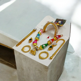 A complete Laddu Gopal Shringaar Set including Mukut, Earrings, Bangles, Mala, and Bansuri for adorning Krishna idols.