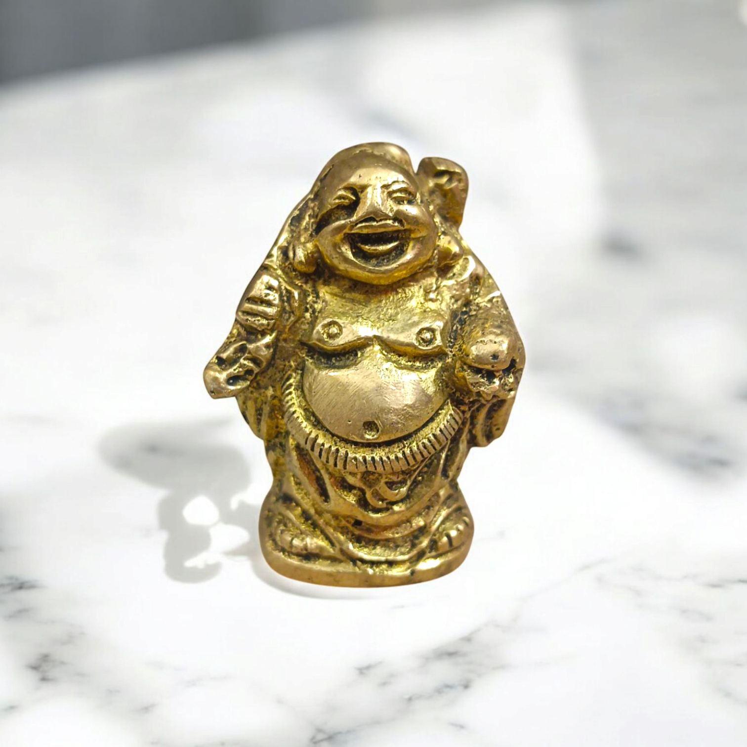 A detailed and polished brass statue of the Laughing Buddha in a standing pose, symbolizing good luck, prosperity, and happiness.