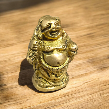 A detailed and polished brass statue of the Laughing Buddha in a standing pose, symbolizing good luck, prosperity, and happiness.