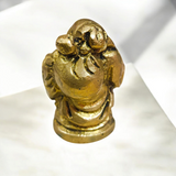 A detailed and polished brass statue of the Laughing Buddha in a standing pose, symbolizing good luck, prosperity, and happiness.