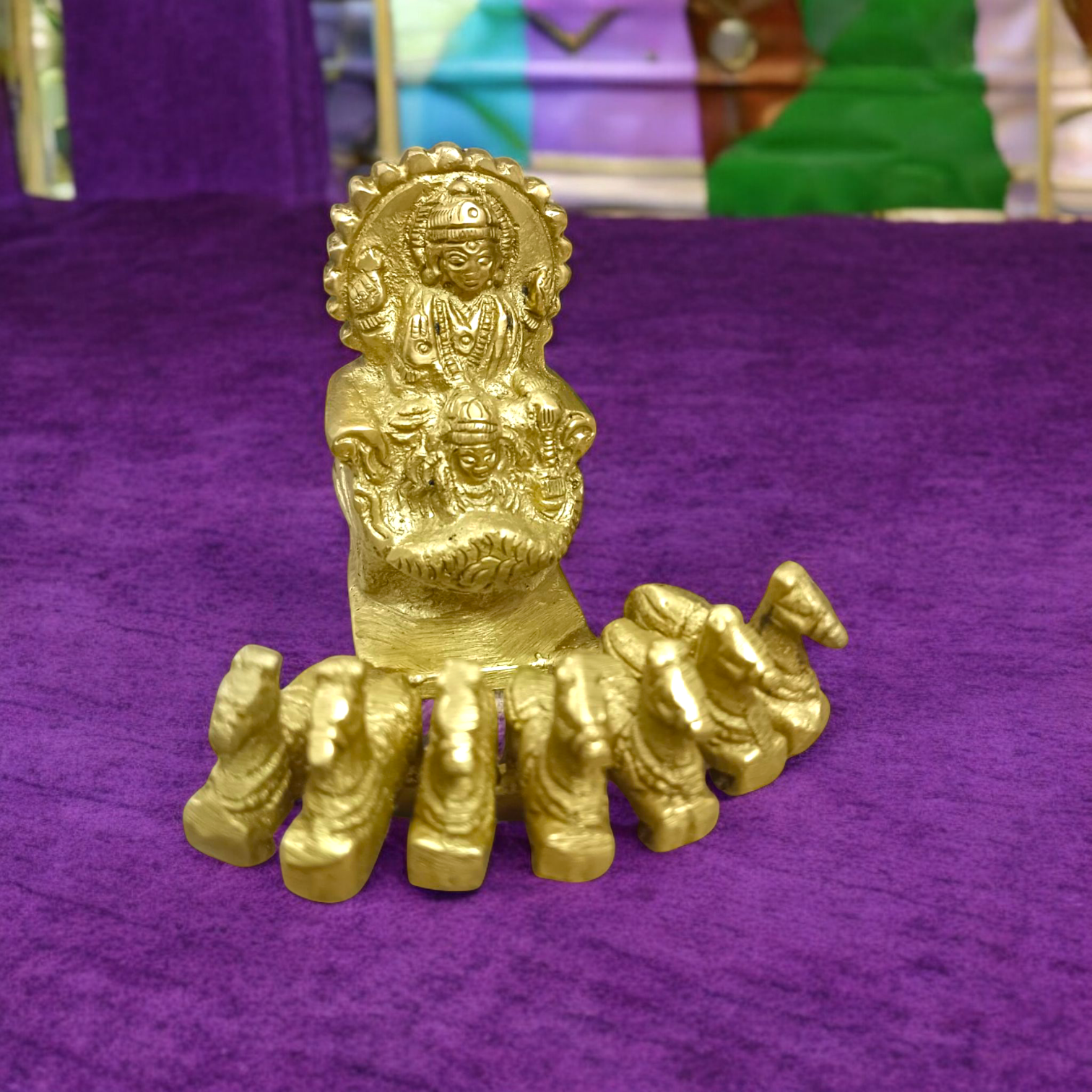 A detailed brass statue of Lord Surya riding a chariot, symbolizing vitality, health, and prosperity, crafted with intricate features and a polished finish.