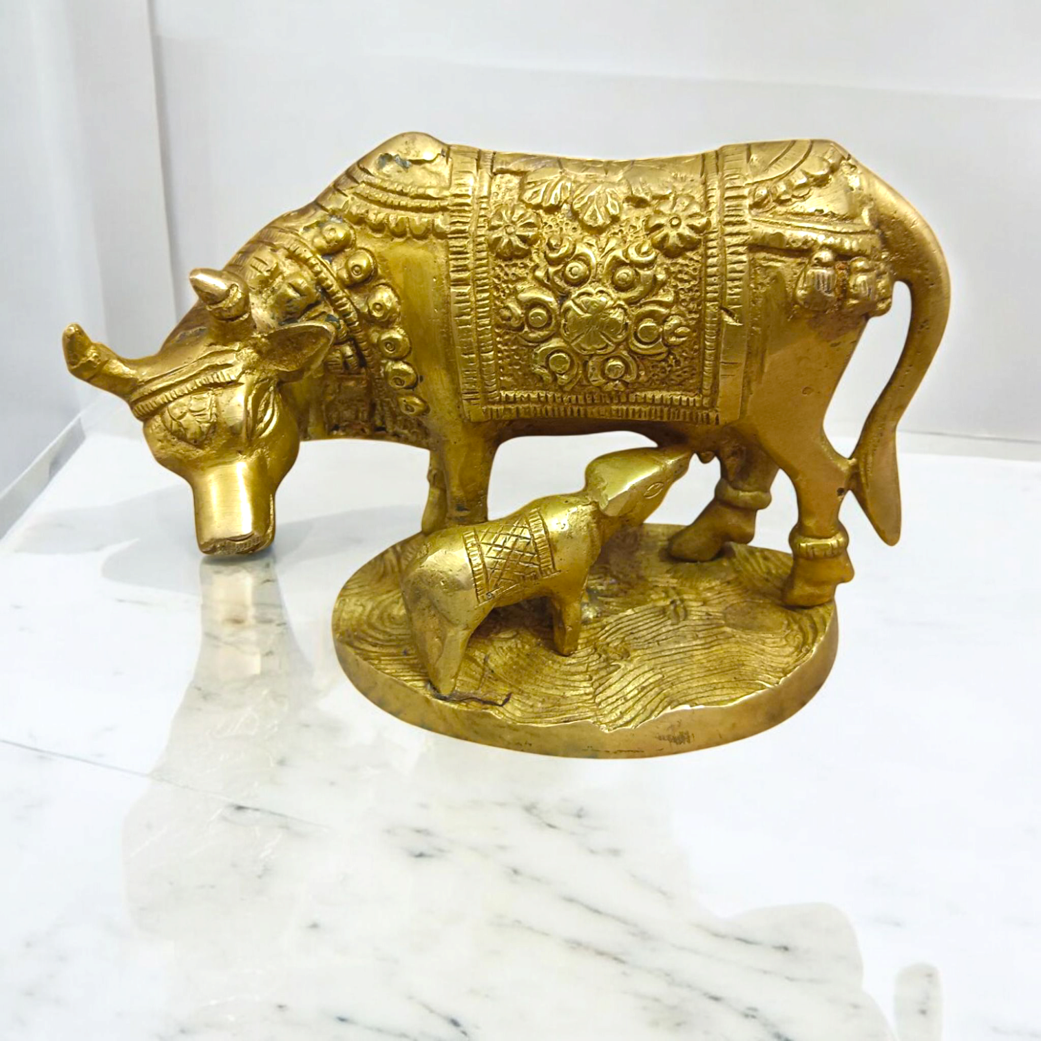 A divine Kamdhenu Cow with Her Child Brass Murti, perfect for worship and pooja, symbolizing prosperity, abundance, and blessings.