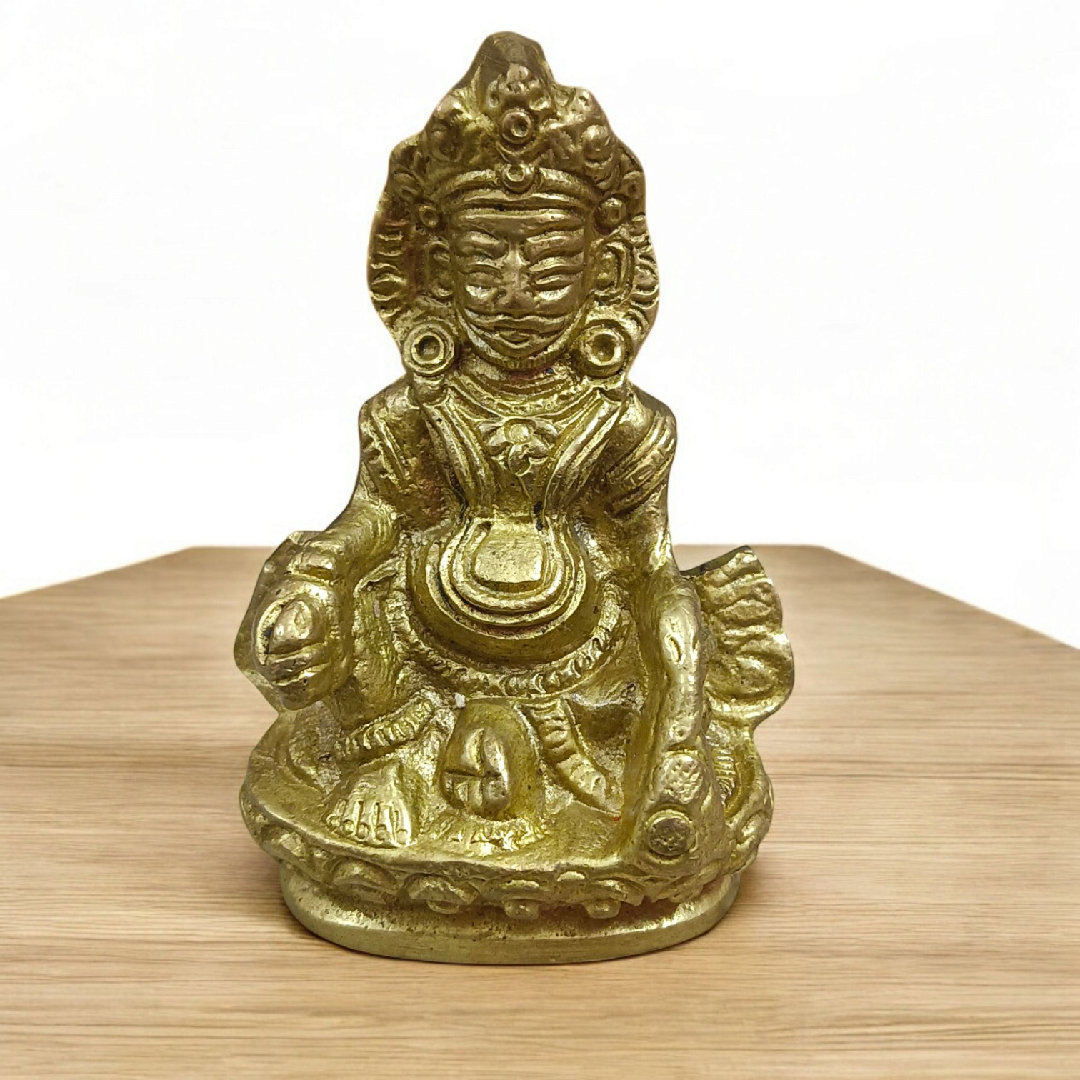 A finely crafted brass statue of Lord Kuber, the god of wealth and prosperity, symbolizing abundance and financial success.