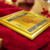 A gold-plated Shri Vaastu Dosh Nivaran Yantra framed beautifully, designed to remove Vastu defects and bring peace, prosperity, and harmony to your space