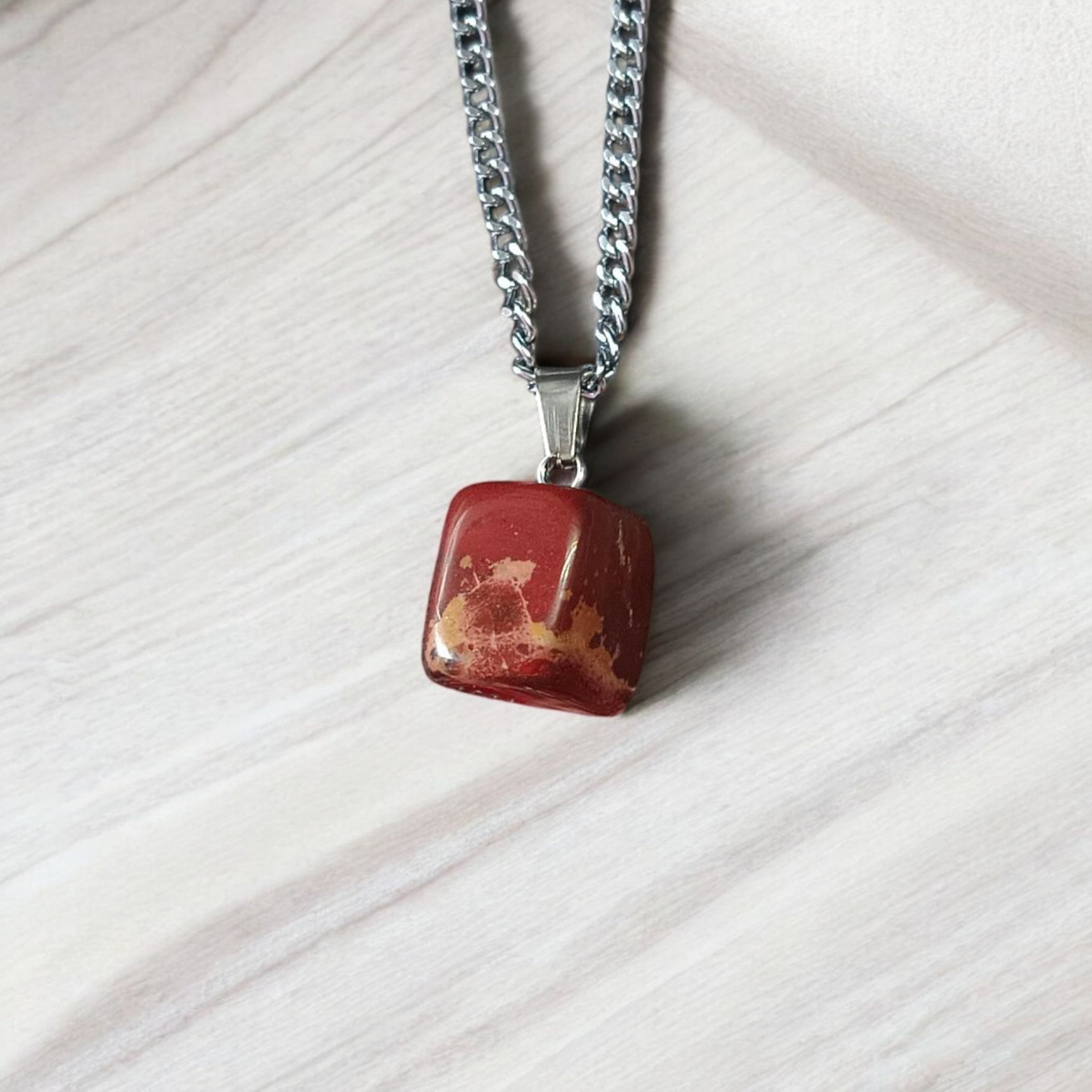 A handcrafted Rainbow Red Jasper Pendant made from natural tumbled gemstone, perfect for healing, emotional stability, and protection