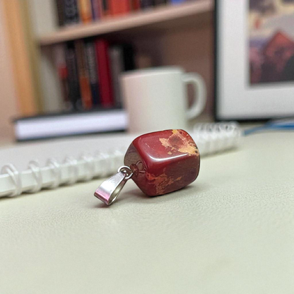 A handcrafted Rainbow Red Jasper Pendant made from natural tumbled gemstone, perfect for healing, emotional stability, and protection