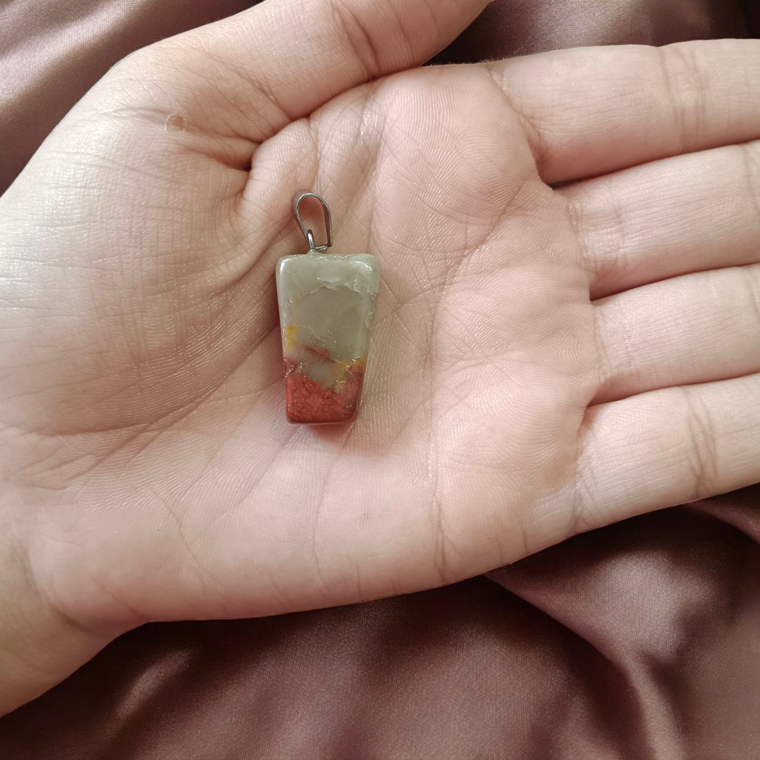 A handcrafted Rainbow Red Jasper Pendant made from natural tumbled gemstone, perfect for healing, emotional stability, and protection