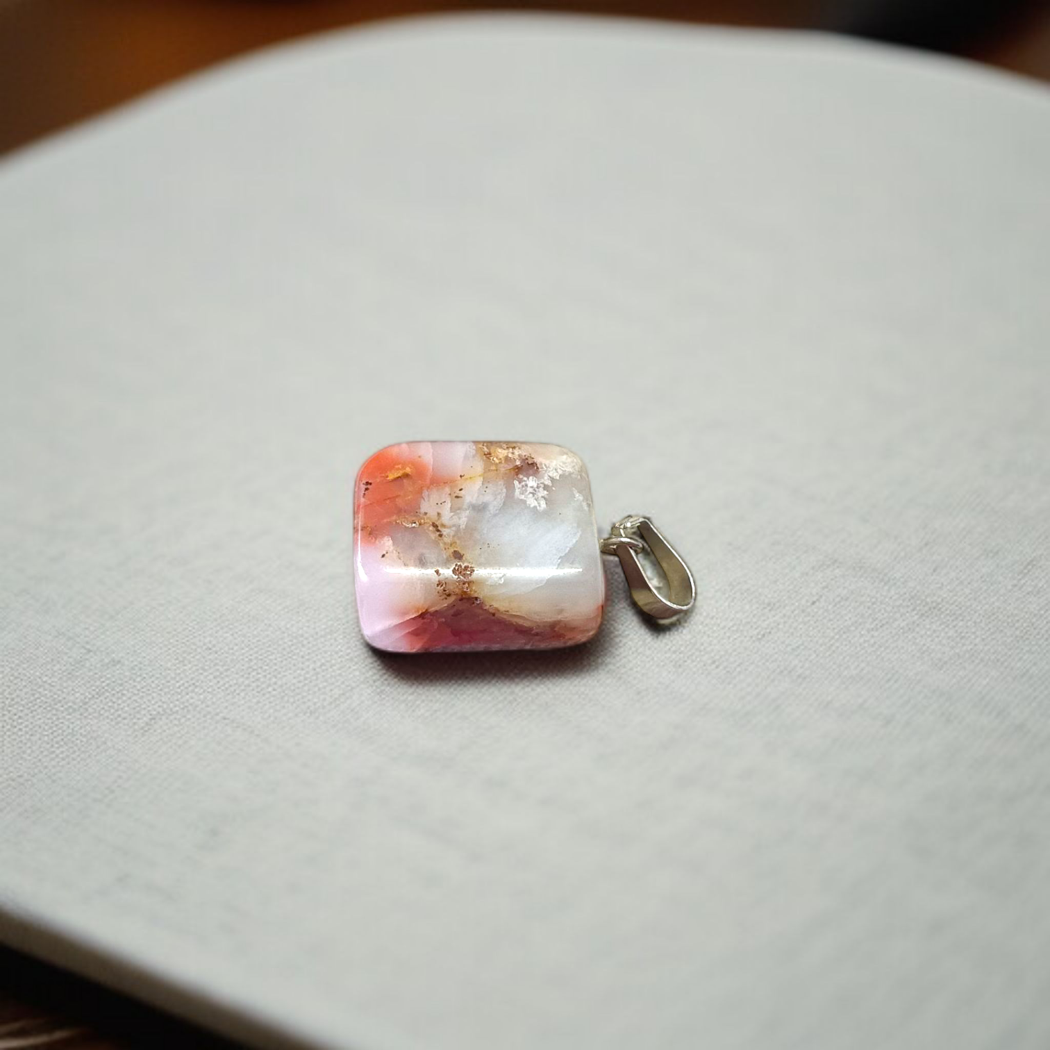 A handcrafted Rainbow Red Jasper Pendant made from natural tumbled gemstone, perfect for healing, emotional stability, and protection