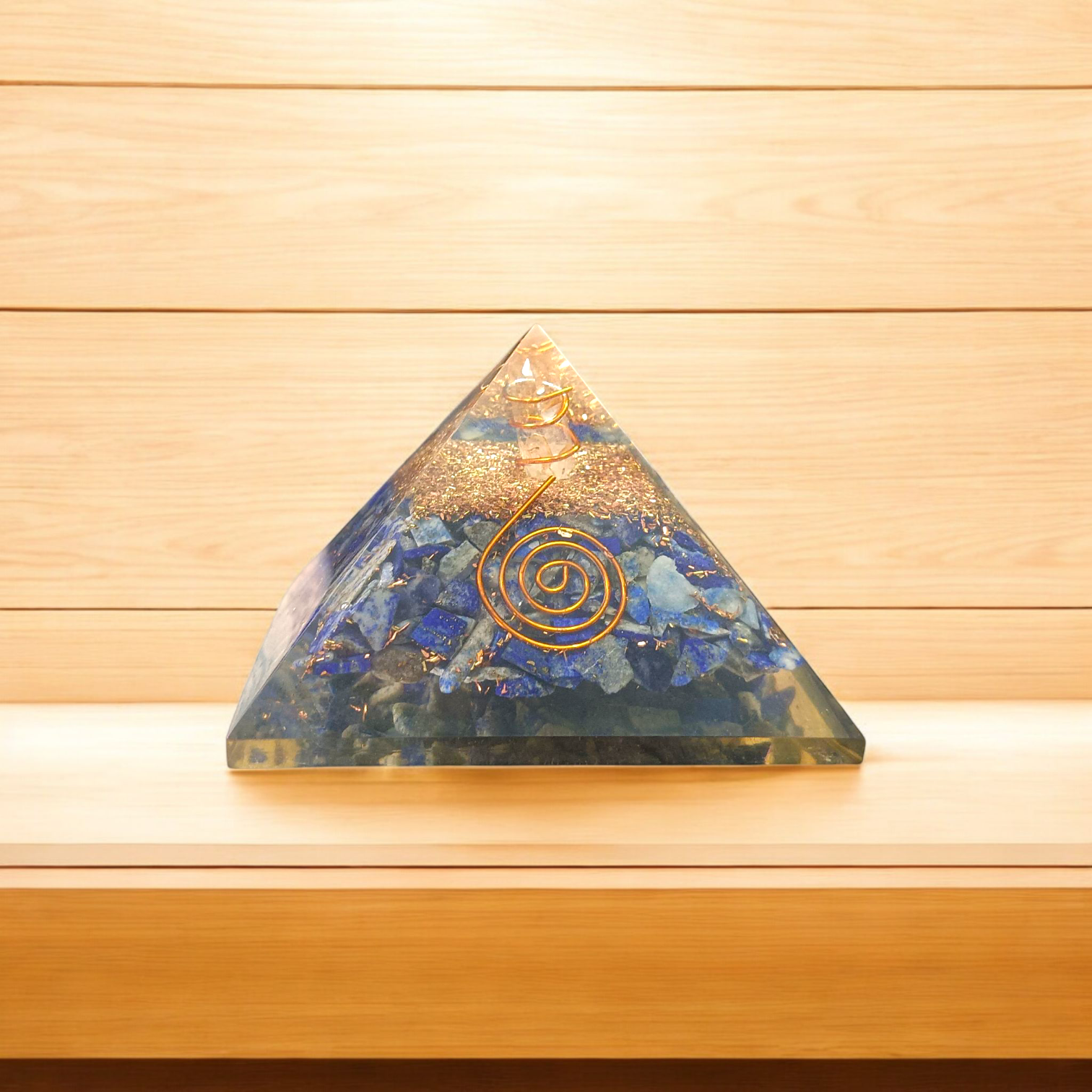 A high-quality image showing the Lapis Lazuli Orgone Pyramid with vibrant blue stones and Orgone resin, emphasizing its spiritual and healing properties