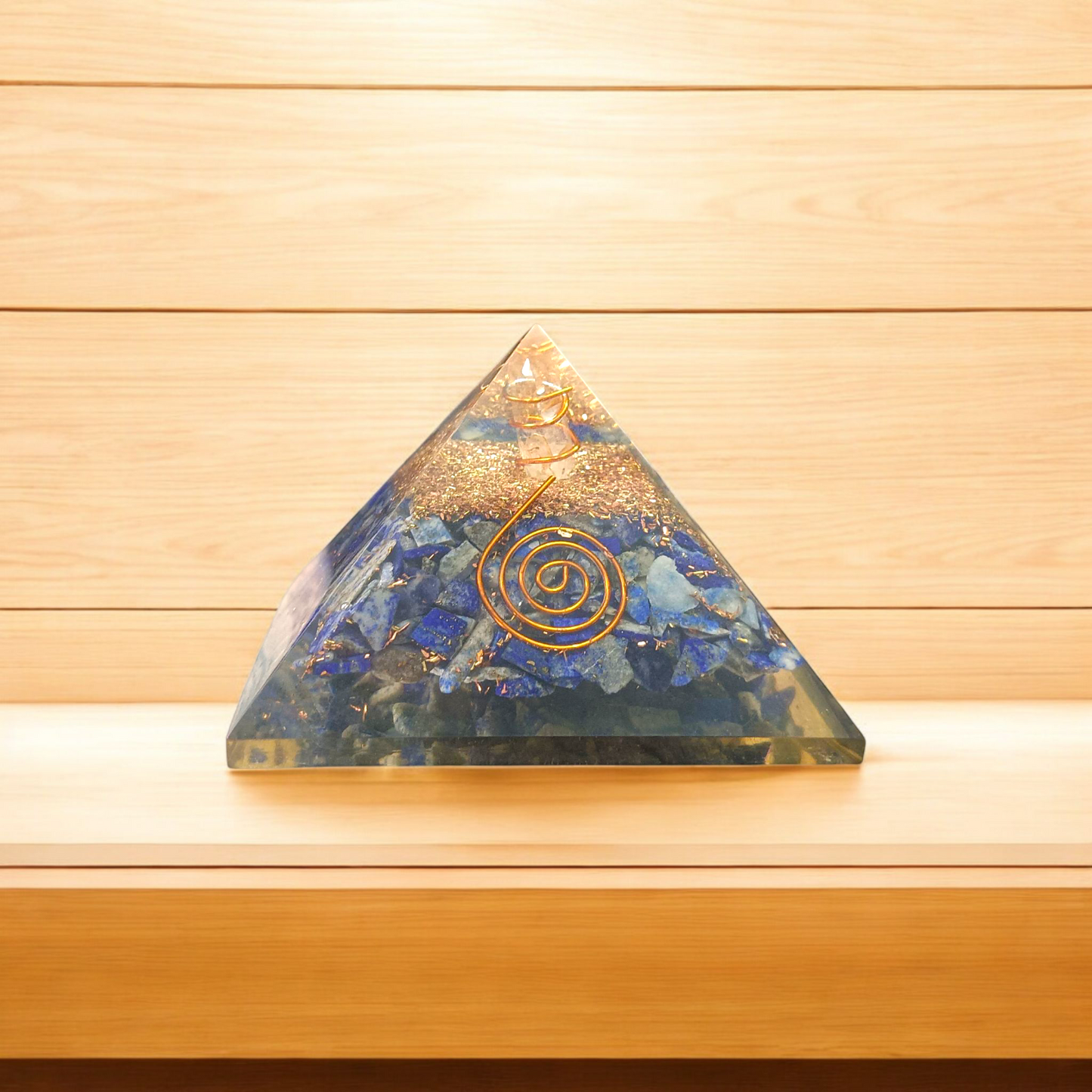 A high-quality image showing the Lapis Lazuli Orgone Pyramid with vibrant blue stones and Orgone resin, emphasizing its spiritual and healing properties