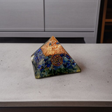 A high-quality image showing the Lapis Lazuli Orgone Pyramid with vibrant blue stones and Orgone resin, emphasizing its spiritual and healing properties
