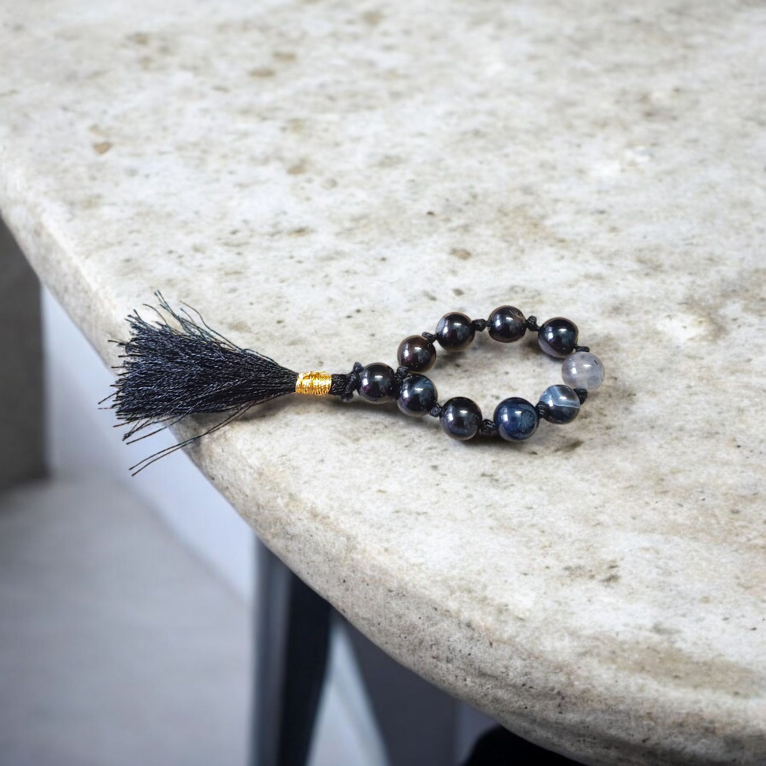 A lab-certified natural black Sulemani finger mala with 9+1 round 8mm Sulemani Hakik beads, ideal for meditation, chanting, and protection