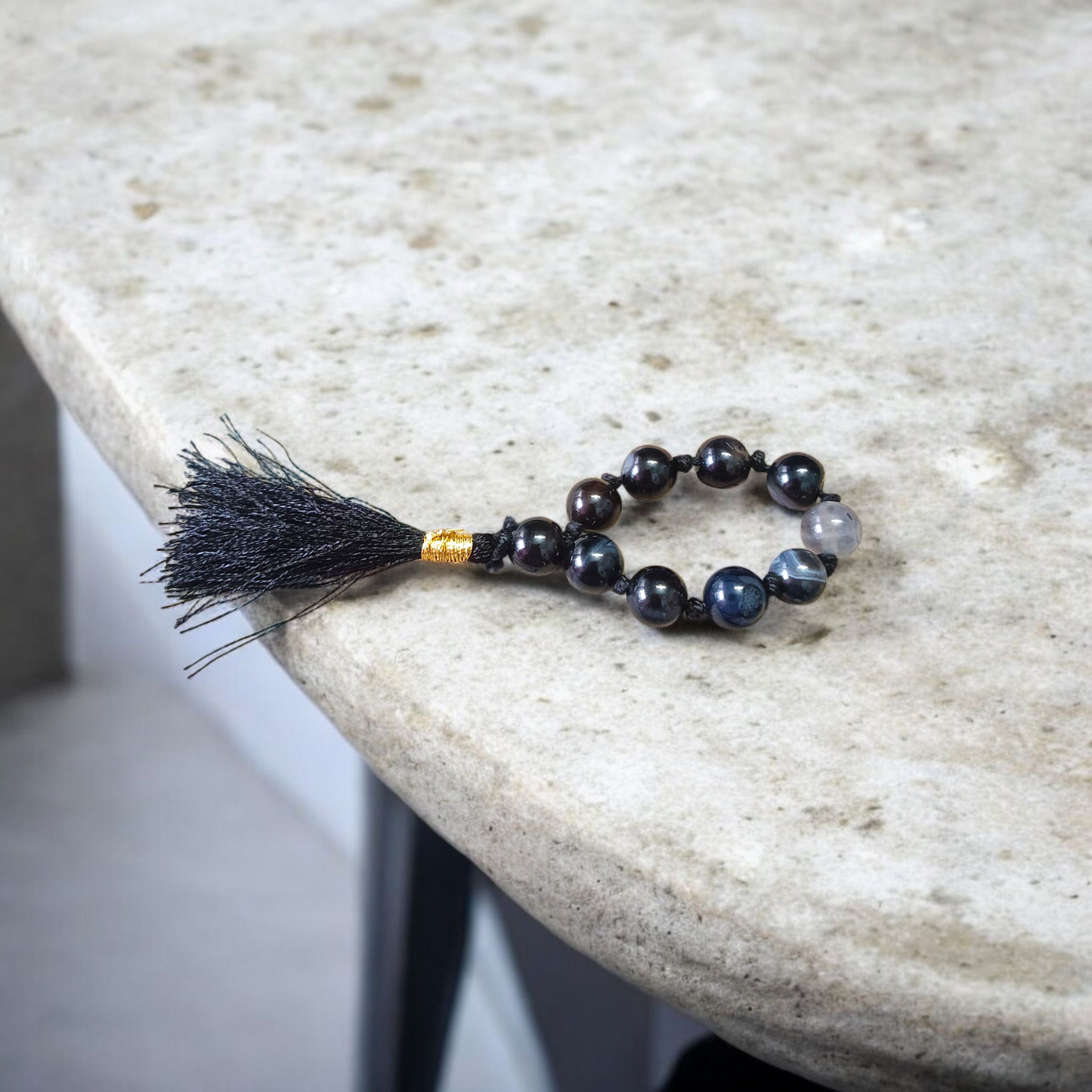 A lab-certified natural black Sulemani finger mala with 9+1 round 8mm Sulemani Hakik beads, ideal for meditation, chanting, and protection
