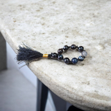 A lab-certified natural black Sulemani finger mala with 9+1 round 8mm Sulemani Hakik beads, ideal for meditation, chanting, and protection