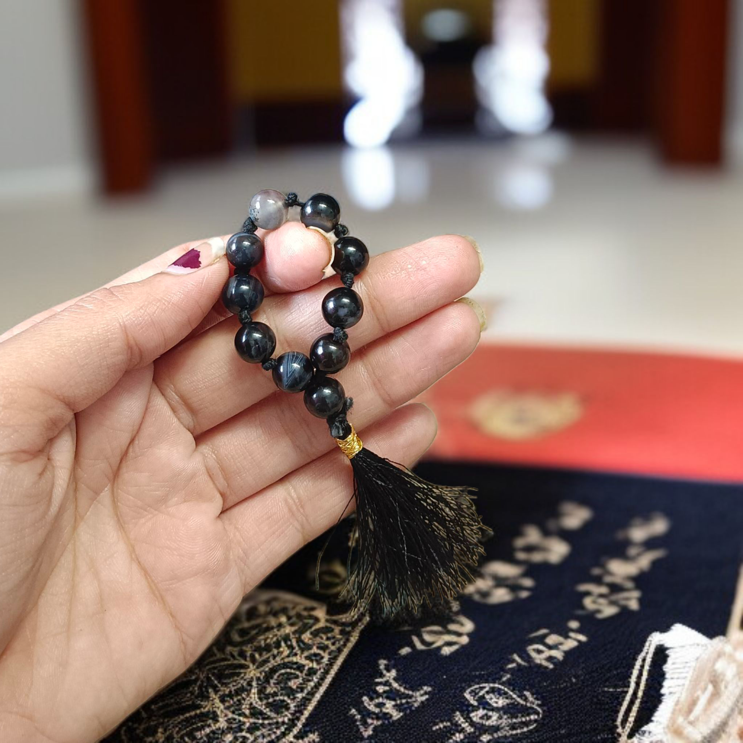 A lab-certified natural black Sulemani finger mala with 9+1 round 8mm Sulemani Hakik beads, ideal for meditation, chanting, and protection