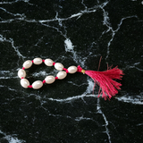 A lab-certified natural pearl finger mala with 9+1 round white pearls (10-11mm) used for chanting, meditation, and spiritual healing