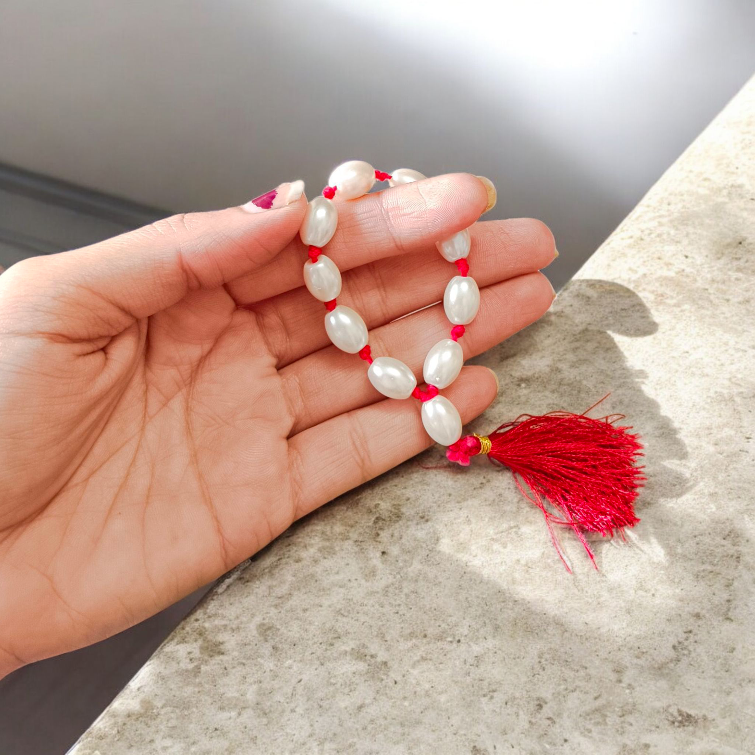 A lab-certified natural pearl finger mala with 9+1 round white pearls (10-11mm) used for chanting, meditation, and spiritual healing