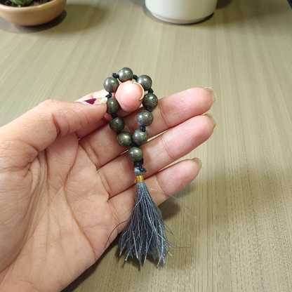 A lab-certified natural pyrite finger mala featuring 9+1 polished 8mm beads, ideal for meditation, chanting, and attracting positive energy