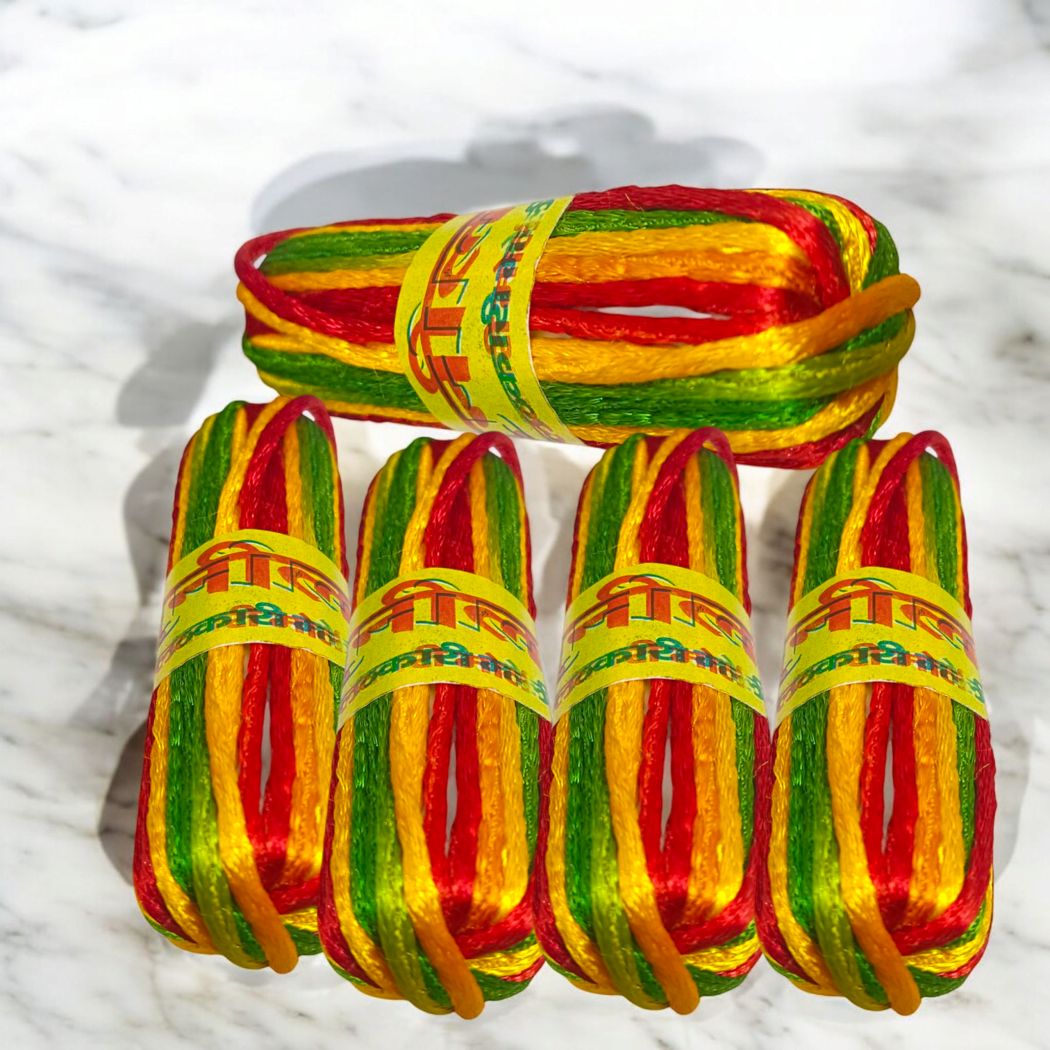 A pack of 5 Silk Pooja Kalawa Moli, multi-color Raksha Sutra Mannat Dhaga threads, each 11 feet in length, used for religious rituals and spiritual protection