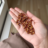 A premium Natural 5 Face Rudraksha Mala with 50 lab-certified 6mm Rudraksha beads, golden caps, and a 1-year golden plating guarantee, symbolizing peace and divine energy