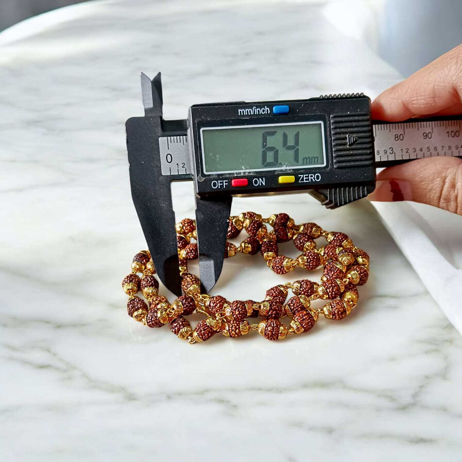 A premium Natural 5 Face Rudraksha Mala with 50 lab-certified 6mm Rudraksha beads, golden caps, and a 1-year golden plating guarantee, symbolizing peace and divine energy