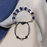 A soothing blue and white crystal bracelet for energy balance, attraction, and emotional healing, displayed neatly with soft lighting