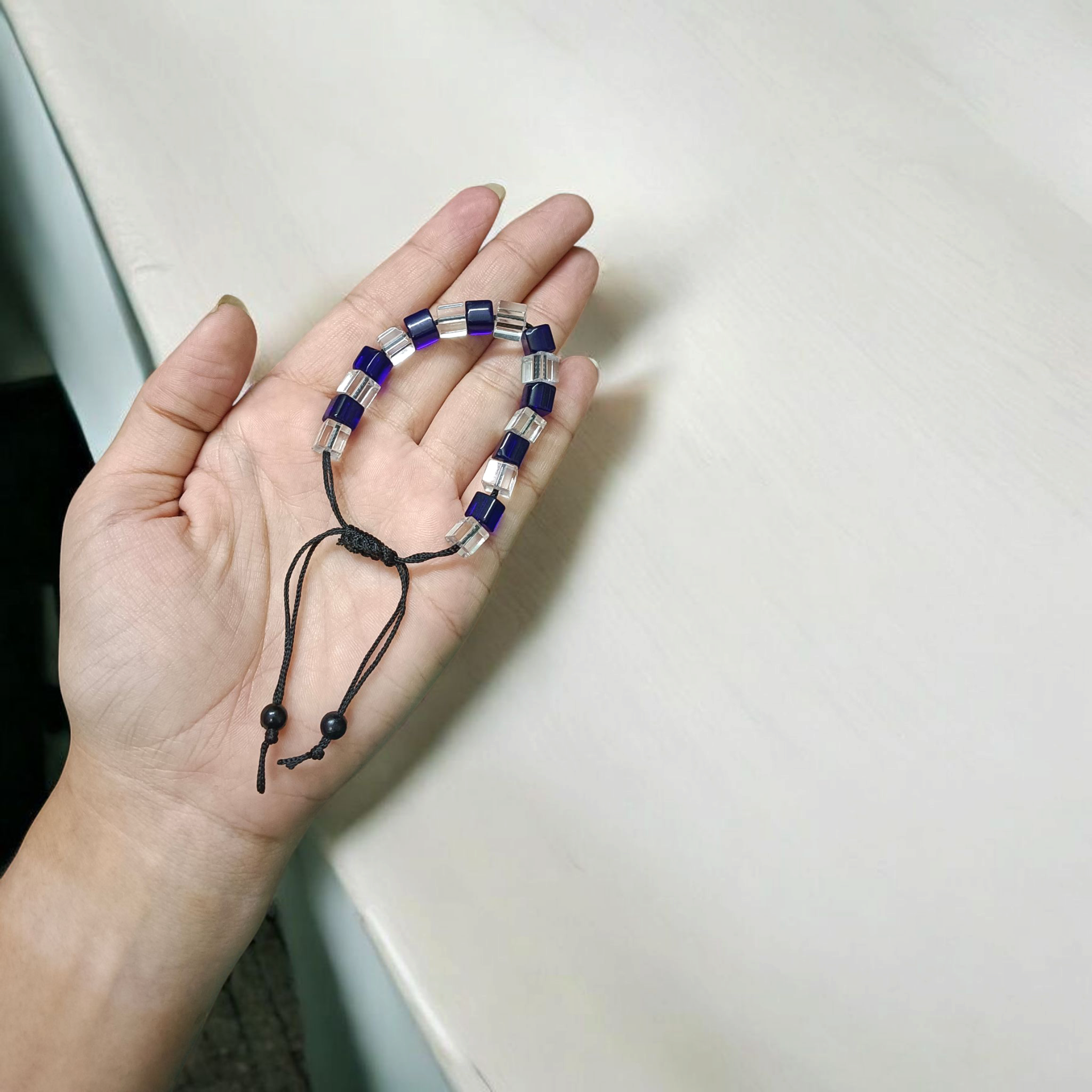 A soothing blue and white crystal bracelet for energy balance, attraction, and emotional healing, displayed neatly with soft lighting