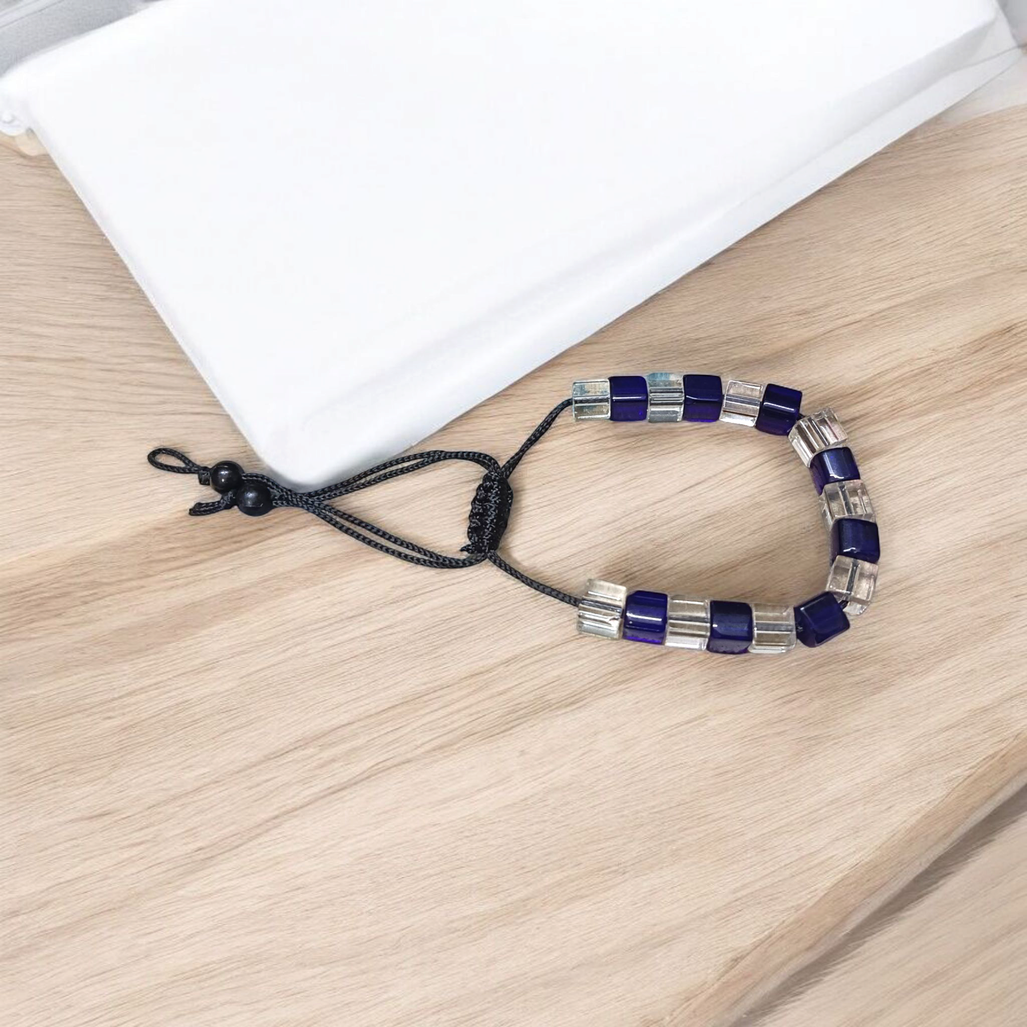 A soothing blue and white crystal bracelet for energy balance, attraction, and emotional healing, displayed neatly with soft lighting