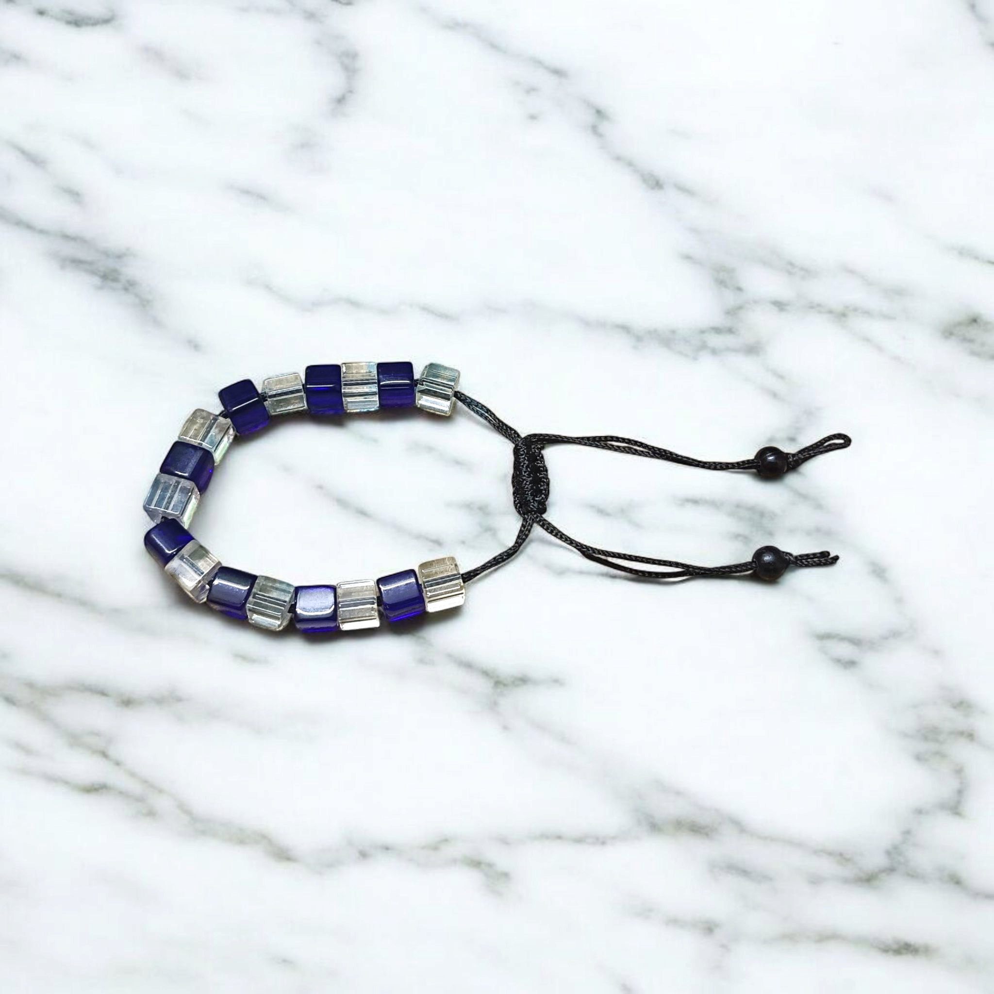 A soothing blue and white crystal bracelet for energy balance, attraction, and emotional healing, displayed neatly with soft lighting